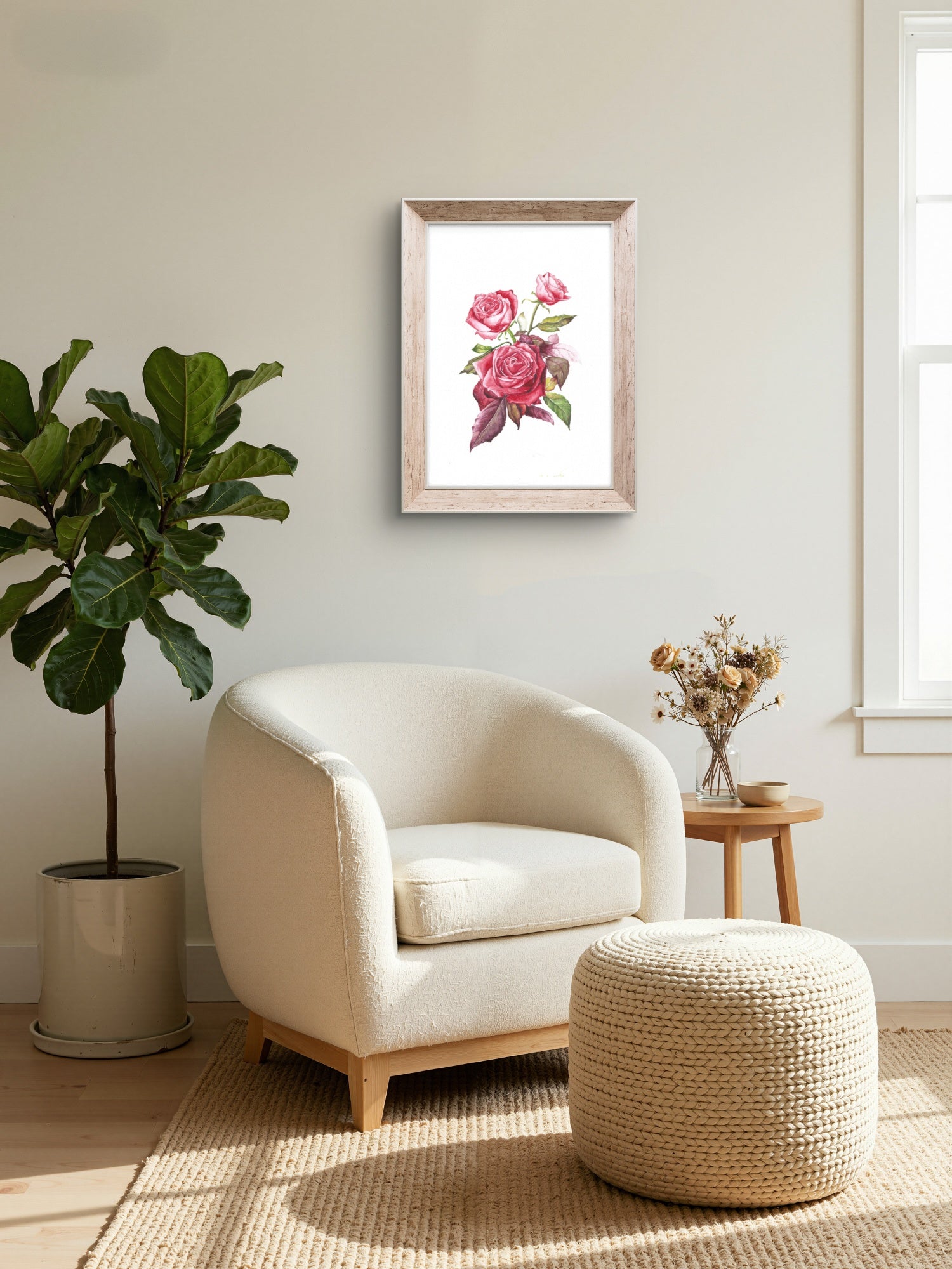 Living room with a white armchair, ottoman, and framed floral print on the wall.